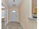 A naturally lit entryway with tile flooring, french doors, and a view of the kitchen at 13173 Sw 65Th Cir, Ocala, FL 34473
