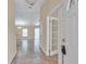Tiled entryway leading to a living area, with glass paneled french doors to the right at 13173 Sw 65Th Cir, Ocala, FL 34473