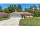 Exterior of a single-story home with a two-car garage and well-maintained lawn at 13173 Sw 65Th Cir, Ocala, FL 34473