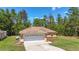 Home exterior with a two-car garage, arched windows, and manicured landscaping at 13173 Sw 65Th Cir, Ocala, FL 34473
