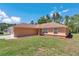 Lovely single-story home features a green lawn with mulch landscaping and beautiful blue sky at 13173 Sw 65Th Cir, Ocala, FL 34473