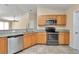 Well-lit kitchen featuring stainless appliances and stone countertops at 13173 Sw 65Th Cir, Ocala, FL 34473