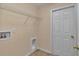 Practical laundry room equipped with utility connections and storage shelf at 13173 Sw 65Th Cir, Ocala, FL 34473