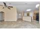 Spacious living room showcasing neutral walls, ceiling fan, and direct access to kitchen at 13173 Sw 65Th Cir, Ocala, FL 34473