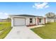 Charming single-story home featuring a one-car garage, manicured lawn, and modern gray and white trim at 13333 Sw 113 Pl, Dunnellon, FL 34432