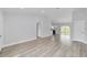 Open-concept living room features contemporary flooring, fresh paint, and a sliding glass door to the backyard at 13333 Sw 113 Pl, Dunnellon, FL 34432