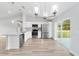 Modern kitchen featuring stainless steel appliances, white cabinets, an island sink, and glass door to backyard at 13344 Sw 112 Pl, Dunnellon, FL 34432