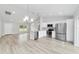 Open kitchen showcases stainless steel appliances, white cabinets, quartz countertops, and views of the living area at 13344 Sw 112 Pl, Dunnellon, FL 34432