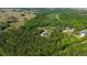Breathtaking aerial view of a stylish home nestled amongst lush green forests and rolling fields, providing a serene escape at 14115 Nw 141St Ave, Williston, FL 32696