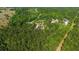 Beautiful aerial view of a modern home surrounded by dense woodlands, highlighting its serene and secluded location at 14115 Nw 141St Ave, Williston, FL 32696