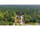 An aerial perspective of a secluded home surrounded by a vast green forest, providing a tranquil and private retreat at 14115 Nw 141St Ave, Williston, FL 32696