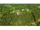 Scenic aerial shot of a charming home nestled in the woods near other homes, offering privacy and natural beauty at 14115 Nw 141St Ave, Williston, FL 32696