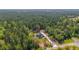 Expansive aerial view of a home surrounded by a dense forest, showcasing its secluded and private setting at 14115 Nw 141St Ave, Williston, FL 32696