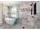 Modern bathroom with glass enclosed shower, large format tile, and soaking tub at 14115 Nw 141St Ave, Williston, FL 32696