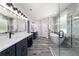 A spacious bathroom with marble floors, and sinks, and a glass shower at 14115 Nw 141St Ave, Williston, FL 32696