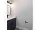 Modern bathroom featuring gray cabinetry with black hardware and a quartz countertop at 14115 Nw 141St Ave, Williston, FL 32696