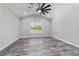 Bright bedroom featuring hardwood floors, neutral colored walls, and a large window at 14115 Nw 141St Ave, Williston, FL 32696