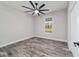 Bedroom with ceiling fan, wood-style tile, and light gray paint at 14115 Nw 141St Ave, Williston, FL 32696