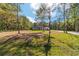 Beautiful single-story home surrounded by mature trees, offering a peaceful and private setting on a sunny day at 14115 Nw 141St Ave, Williston, FL 32696