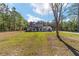 Beautifully landscaped front yard with a covered porch on this charming single-story home with white and black trim at 14115 Nw 141St Ave, Williston, FL 32696