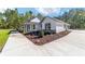 A well-maintained single-story home featuring a covered porch and neatly landscaped grounds at 14115 Nw 141St Ave, Williston, FL 32696