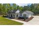 Spacious single-story home showcasing a covered porch and meticulously landscaped surroundings at 14115 Nw 141St Ave, Williston, FL 32696