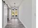 Well-lit foyer featuring a modern light fixture and views to the front lawn from the double glass front doors at 14115 Nw 141St Ave, Williston, FL 32696