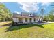 Beautiful single-story home with a covered porch, modern accents, and a well-manicured lawn at 14115 Nw 141St Ave, Williston, FL 32696