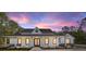 Beautiful single-story home featuring a covered porch and landscaped front yard against a stunning sunset backdrop at 14115 Nw 141St Ave, Williston, FL 32696
