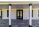 Inviting front porch featuring dark trim, gray wood-look tile, and a double door entry with glass sidelights at 14115 Nw 141St Ave, Williston, FL 32696