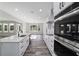 Modern kitchen with a view of an adjacent dining and living area with many windows and natural light at 14115 Nw 141St Ave, Williston, FL 32696