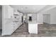 Spacious kitchen with white cabinets, a central island, stainless steel appliances, and modern finishes at 14115 Nw 141St Ave, Williston, FL 32696
