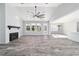 Spacious living room with a fireplace, large windows, and an open layout, perfect for entertaining at 14115 Nw 141St Ave, Williston, FL 32696