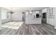 Open-concept living space showcasing a modern kitchen, living room, and dining area with lots of natural light at 14115 Nw 141St Ave, Williston, FL 32696