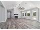 Bright living room with a vaulted ceiling, fan, fireplace, and plenty of natural light from multiple windows at 14115 Nw 141St Ave, Williston, FL 32696