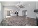 Bright, open-concept living room with modern fan, wood floors, and kitchen view at 14115 Nw 141St Ave, Williston, FL 32696