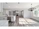 Open-concept living space with a modern kitchen, dining area, and living room with a fireplace at 14115 Nw 141St Ave, Williston, FL 32696