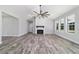 Spacious living room with a modern fireplace, large windows, and an open layout, bathed in natural light at 14115 Nw 141St Ave, Williston, FL 32696