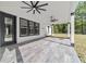 Covered patio with wood-look flooring, ceiling fans, and a seamless transition to the outdoors for relaxation and entertainment at 14115 Nw 141St Ave, Williston, FL 32696