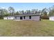 Exterior view of a home with a wide backyard and patio at 15840 Sw 38 Pl, Ocala, FL 34481