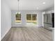 Dining area with a modern chandelier, sliding doors to backyard, and stainless steel refrigerator at 15840 Sw 38 Pl, Ocala, FL 34481