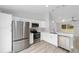 Modern kitchen with stainless steel appliances, white cabinets, and quartz countertops at 15840 Sw 38 Pl, Ocala, FL 34481