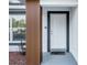Inviting entryway featuring a white front door, textured walls, and a modern, decorative wood post at 15854 Sw 38 Pl, Ocala, FL 34481