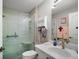 Modern bathroom features a frameless glass shower with a built-in bench and brushed gold fixtures at 16751 Se 84Th Colerain Cir, The Villages, FL 32162