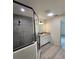 Modern bathroom featuring a tiled shower with sleek glass enclosure, white vanity, and granite countertop at 22764 Sw Sea Cliff Ave, Dunnellon, FL 34431