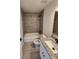 Full bathroom featuring tiled shower over tub, gray backsplash, and granite vanity countertop at 22764 Sw Sea Cliff Ave, Dunnellon, FL 34431