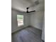 Clean and modern bedroom with luxury vinyl plank flooring, ceiling fan, and natural light at 22764 Sw Sea Cliff Ave, Dunnellon, FL 34431