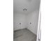Bright laundry room with white walls, gray floors, and hookups for a washer and dryer at 22764 Sw Sea Cliff Ave, Dunnellon, FL 34431