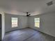Bright main bedroom with modern ceiling fan, LVP flooring, and two windows to allow for natural light at 22764 Sw Sea Cliff Ave, Dunnellon, FL 34431