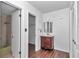 Bathroom featuring a wooden vanity, mosaic tile, and access to the closet at 2837 Ne 3Rd St # 103, Ocala, FL 34470